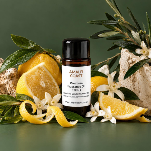 Amalfi Coast fragrance oil bottle with whole and sliced lemons, curled lemon peel, white blossoms, leafy branches and pale rocks.