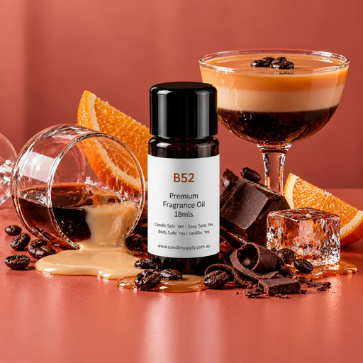 B52 fragrance oil bottle with a layered cocktail, a tipped glass spilling cream, orange wedges, coffee beans, chocolate and ice.
