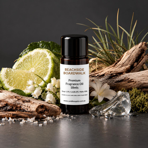 Beachside Boardwalk fragrance oil bottle with driftwood, lime slices, coastal grasses, white flowers, salt crystals and a clear stone.