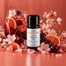 Cherry Blossom Sangria fragrance oil bottle with a red iced fruit drink, cherries, blood orange slices and pink blossom branches.