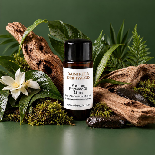 Daintree & Driftwood fragrance oil bottle with weathered driftwood, wet green leaves, fern fronds, moss, white flowers and dark stones.