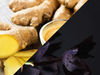 Ginger root with a close-up of sliced ginger and a dark background with a purple flower.