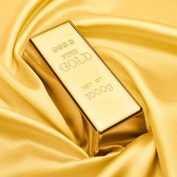 Gold bar with '999.9 Fine Gold' text on a gold fabric background