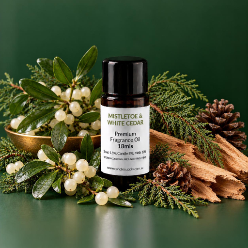 Mistletoe & White Cedar fragrance oil bottle with white berries, green leaves, evergreen branches, pine cones and split wood.