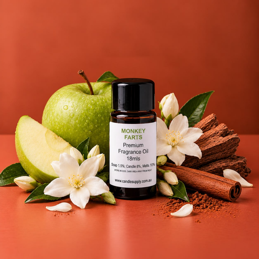 Monkey Farts fragrance oil bottle with a green apple, apple wedge, white flowers, cinnamon and pieces of wood.
