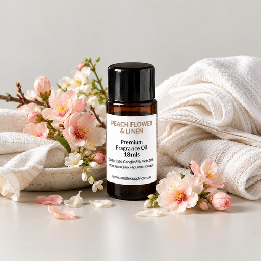 Peach Flower & Linen fragrance oil bottle with folded white linen, rolled towels, pink blossom branches and scattered petals.