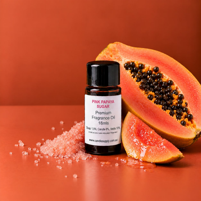 Pink Papaya Sugar fragrance oil bottle with a halved papaya with black seeds, a papaya wedge and pink sugar crystals.