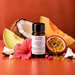 Poolside Paradise fragrance oil bottle with coconut, green and orange melon wedges, passionfruit and a pink hibiscus flower.