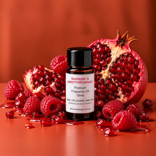 Raspberry & Sweet Pomegranate fragrance oil bottle with pomegranate halves, fresh raspberries and scattered pomegranate seeds.