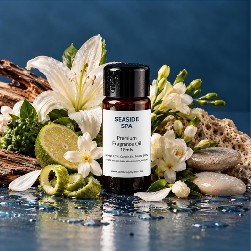 Seaside Spa fragrance oil bottle with white lilies and blossoms, citrus slices, driftwood, smooth stones and a natural sponge.
