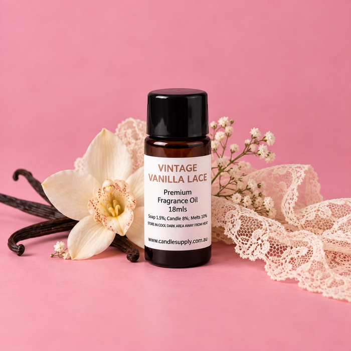 Vintage Vanilla Lace fragrance oil bottle with dark vanilla pods, a white vanilla flower, delicate white blossoms and cream lace.