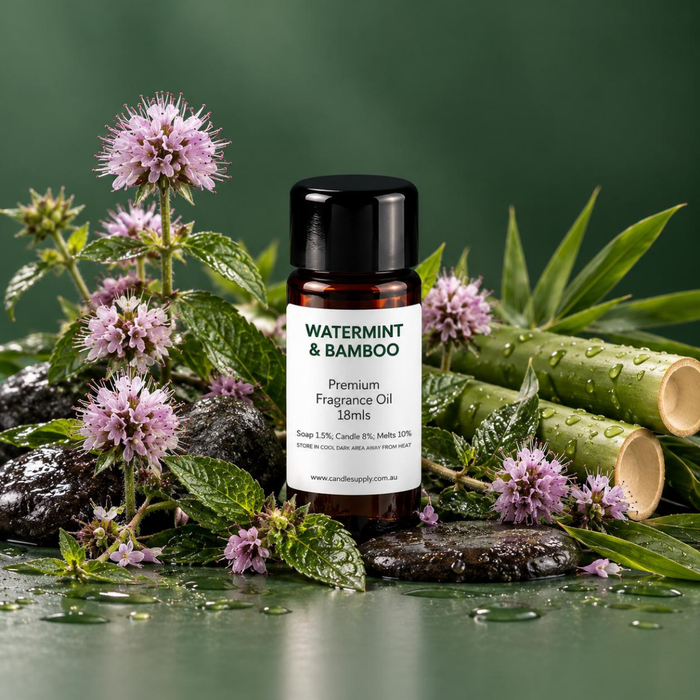 Watermint & Bamboo fragrance oil bottle with cut bamboo stems, mint leaves, purple flowers and wet dark stones.